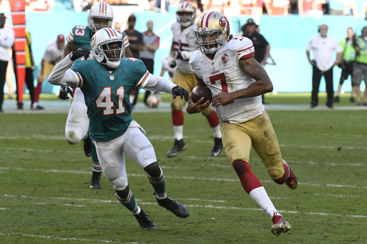 Colin Kaepernick, playing in a 2016 game against the Dolphins, continues to press his grievance against the league, alleging that he's being blackballed. (AP) 