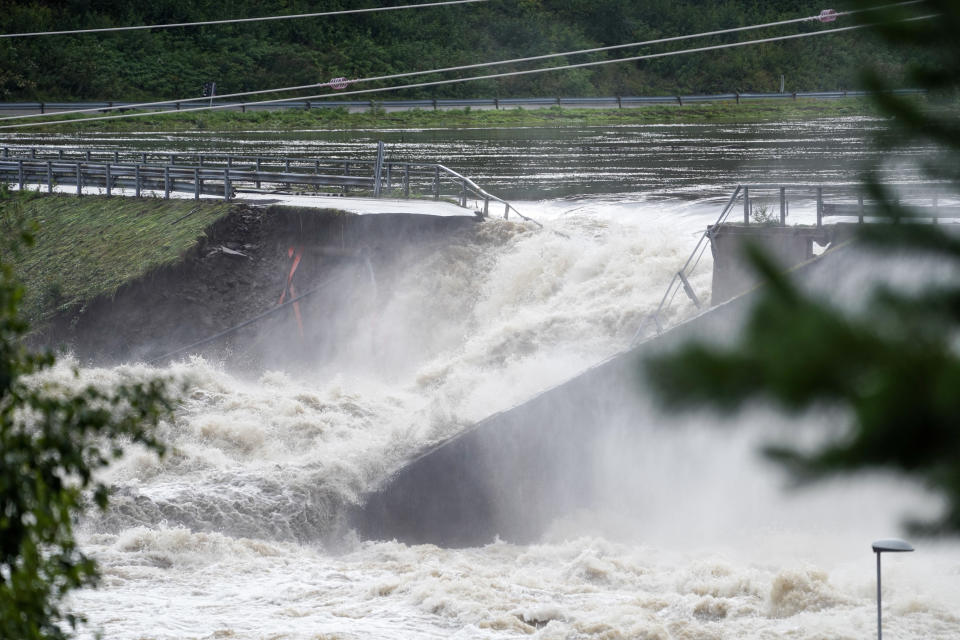 Water breaks through the dam at Braskereidfoss, Norway, Wednesday, Aug. 9, 2023. Authorities in Norway say a dam has partially burst following days of heavy rain that triggered landslides and flooding in the mountainous southern parts of the country. Communities downstream already had been evacuated. (Cornelius Poppe/NTB Scanpix via AP)