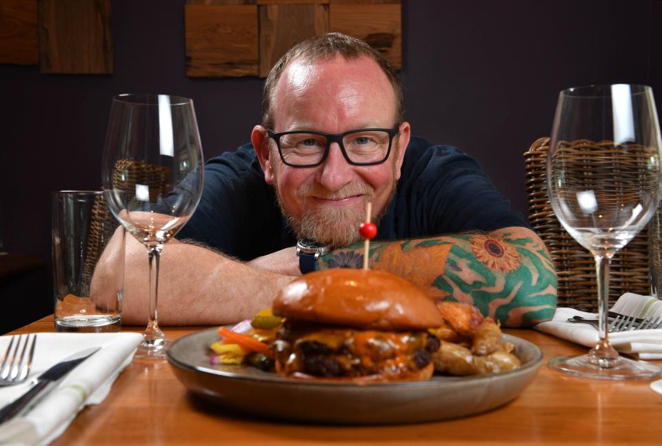 Owner and chef Steve Phelps serves My Uncle’s Burger at Indigenous in Sarasota.