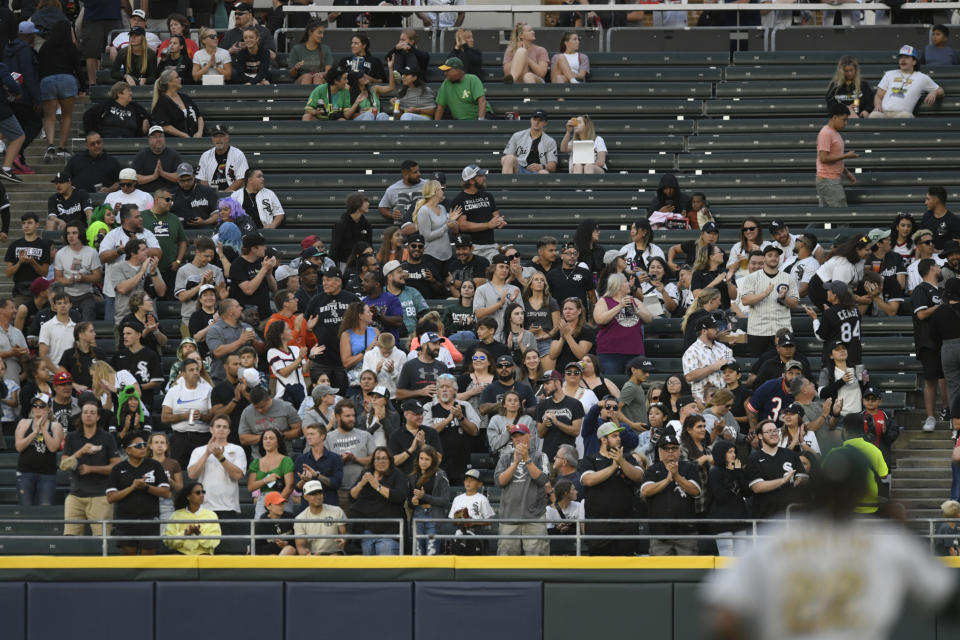 People sit in a section where a shooting occurred the night before, during a baseball game between the Chicago White Sox and the Oakland Athletics, Saturday, Aug. 26, 2023, in Chicago. (AP Photo/Paul Beaty)