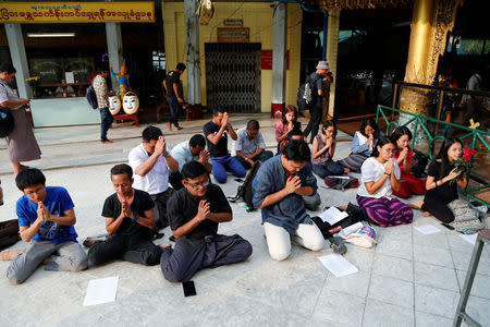 Friends and relatives of arrested Reuters journalists Wa Lone and Kyaw Soe Oo pray at Shwedagon Pagoda in Yangon, Myanmar, January 7, 2018. REUTERS/Stringer