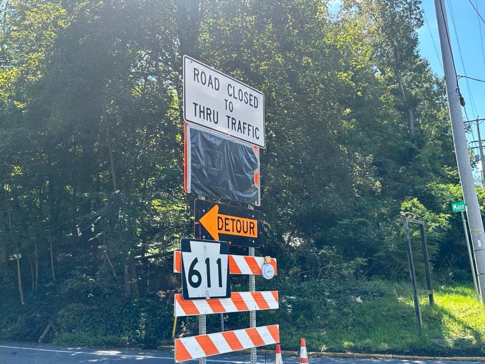 A sign that reads "Road Closed to Thru Traffic" points travelers to the way of a detour on Sept. 12, 2023, in Delaware Water Gap as a section of Route 611 remains closed.