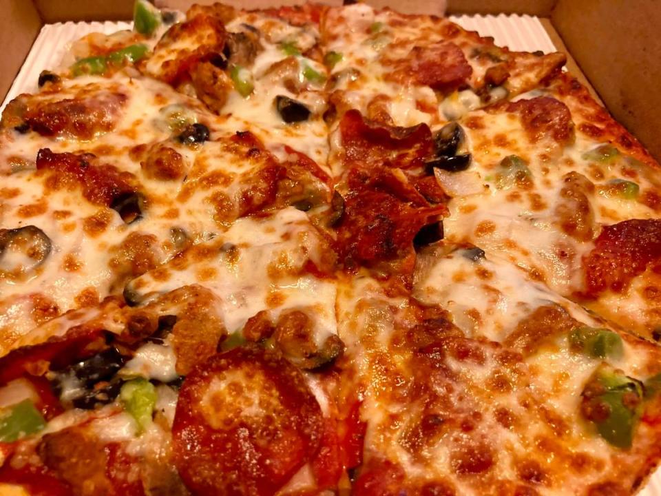 A “CowPie Deluxe” small pizza with pepperoni, Italian sausage, mushroom, green peppers, onions, black olives from CowPies Pizza Co.