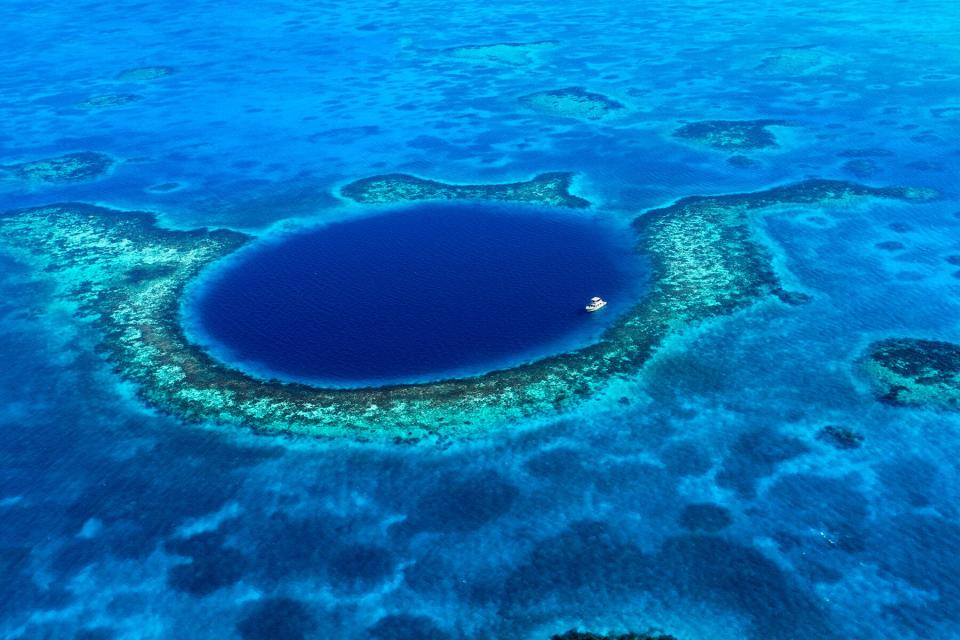 An aerial view of a boat moored in the Great Blue Hole off the coast of Belize