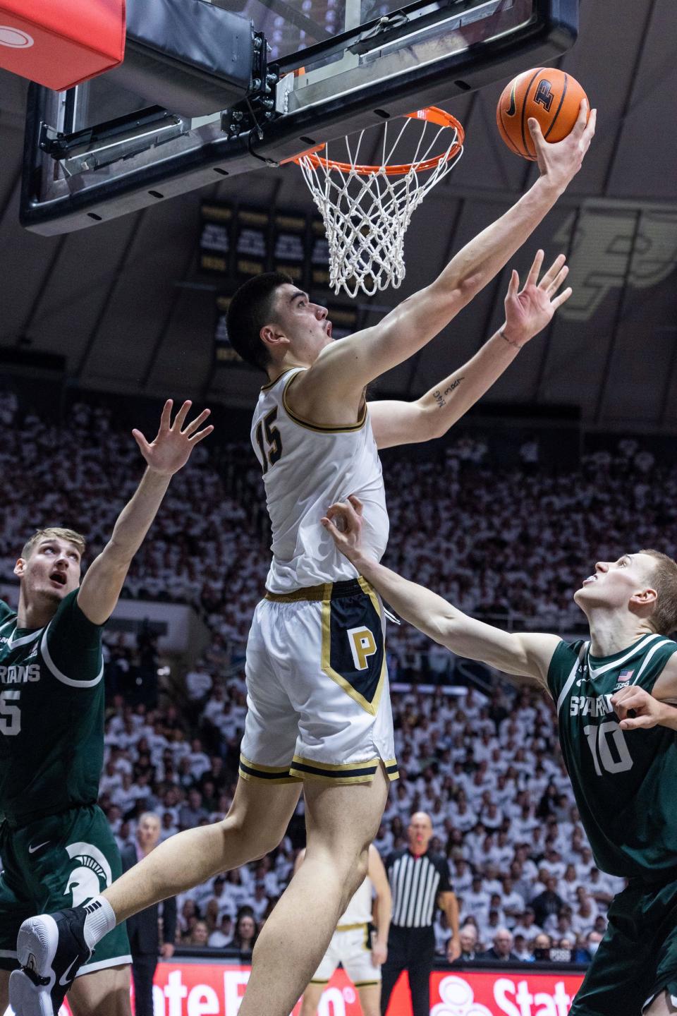 Purdue center Zach Edey shoots the ball while Michigan State center Carson Cooper, left, and forward Joey Hauser defend in the second half of MSU's 77-61 loss on Sunday, Jan. 29, 2023, in West Lafayette, Indiana.