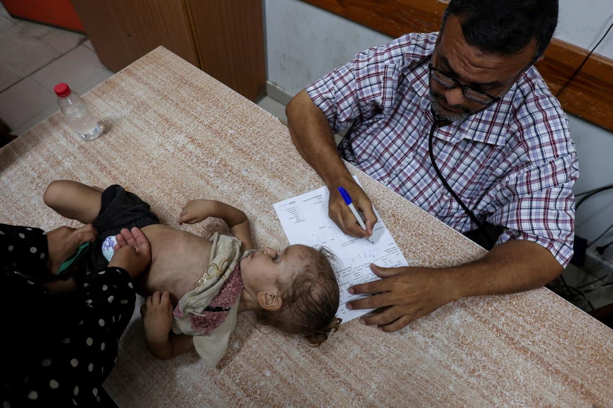 A Palestinian girl is examined by a doctor amid fears over the spread of polio after the first case was reported by the Ministry of Health (Reuters)