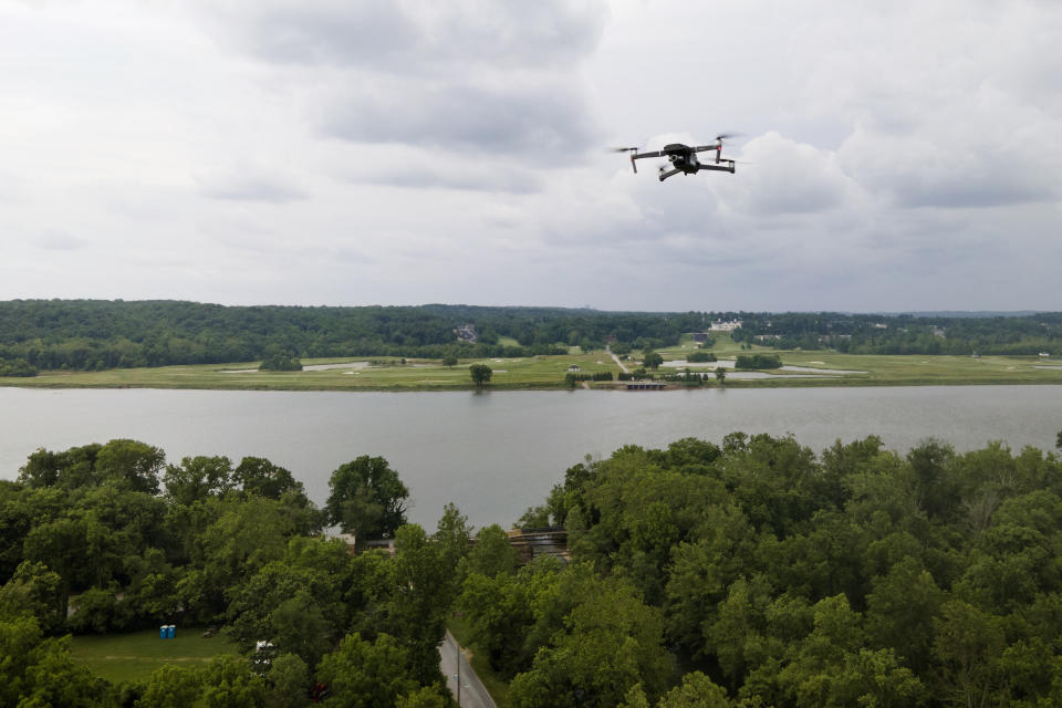A drone operated by Martin Lizely, Grand Riverkeeper with LEAD Agency in Miami, Okla., flies with the Potomac River at a distance during a training session, Tuesday, June 7, 2022, in Poolesville, Md. People who work to protect rivers and waterways have begun using drones to catch polluters in places where wrongdoing is difficult to see or expensive to find. The images they capture have already been used as evidence to formally accuse companies of wrongdoing. (AP Photo/Julio Cortez)