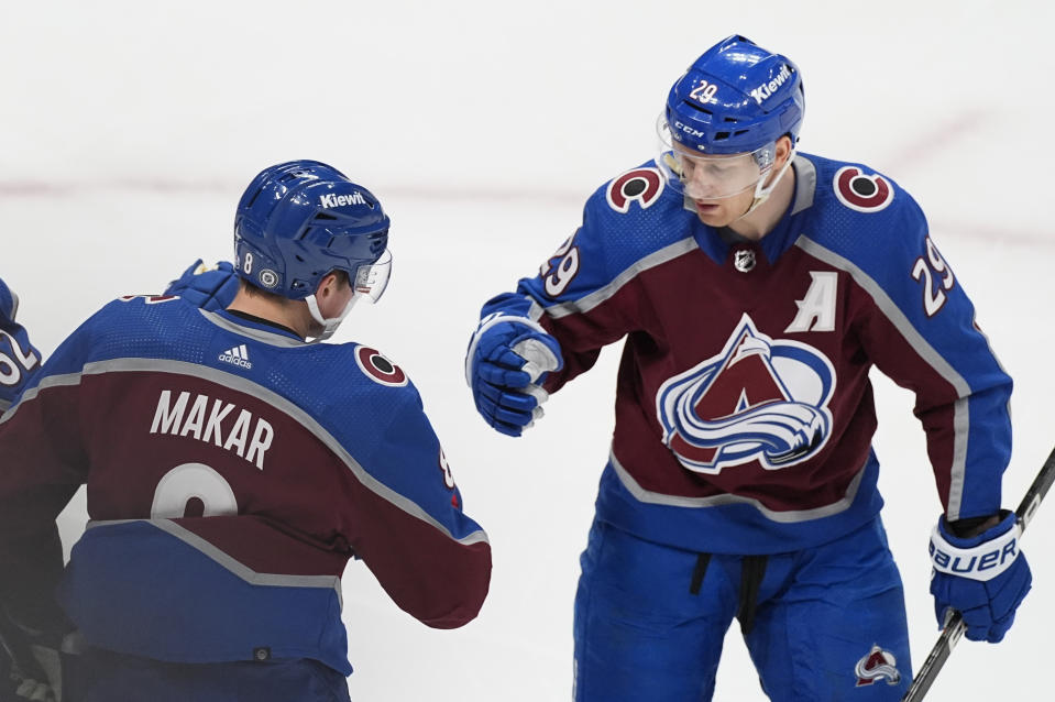 Colorado Avalanche defenseman Cale Makar, left, who scored against the Detroit Red Wings, is congratulated by Nathan MacKinnon during the first period of an NHL hockey game Wednesday, March 6, 2024, in Denver. (AP Photo/David Zalubowski)