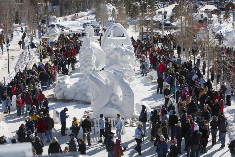 COMMERCIAL IMAGE - In this photograph taken by AP Images for Breckenridge Chamber Resort, the crowd of hundreds of people surrounds 15 snow sculpture at the Breckenridge International Snow Sculpture Championships, on Saturday, Jan., 28, 2012 in Breckenridge Colo. The sculptures started with a 10 foot by 10 foot by 12 foot high solid block of snow and will have a total of 65 hours to finish their sculpture creation at the 22 annual competition. The sculptures will remain on display at the open air exhibit through Feb. 5, at the Riverwalk Center downtown Breckenridge.(Nathan Bilow /AP Images for Breckenridge Chamber Resort)