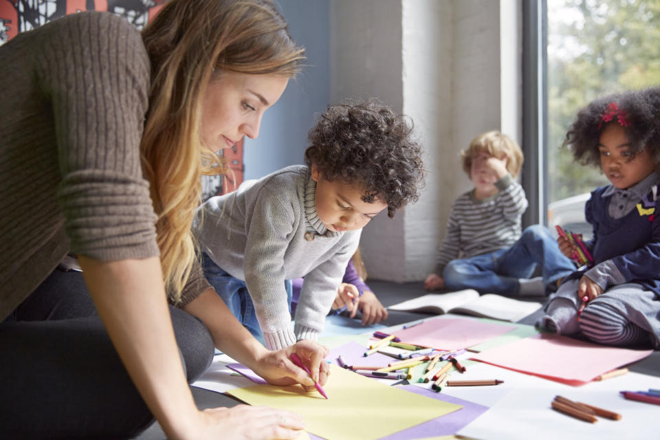 Children play with a teacher at a daycare center