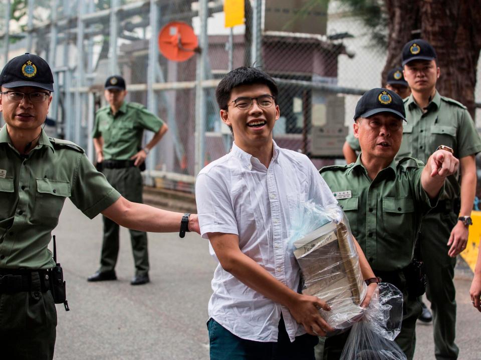 The prominent Hong Kong student activist Joshua Wong was released from prison on Monday and immediately vowed to join the protest movement against a controversial Beijing-backed change to extradition laws.Mr Wong, 22, was convicted of contempt in relation to his activities leading the 2014 Umbrella Movement protests, which blocked major roads and shut down parts of Hong Kong for 79 days.His release after serving five weeks of a two-month sentence comes amid a fresh political crisis, with demonstrators demanding the resignation of the city’s chief executive Carrie Lam.Ms Lam again postponed the extradition bill at the weekend, after it triggered some of the most violent clashes between protesters and police in decades.The bill would make it easier for Hong Kong to extradite suspects to many countries including mainland China. Critics say it will allow Beijing to abduct dissidents for show trials, undermining Hong Kong’s autonomy.After leaving prison, Mr Wong laid flowers at a makeshift memorial outside a shopping mall where a protester fell to his death on Saturday night.He tweeted: “Hello world and hello freedom. GO HONG KONG!! Withdraw the extradition bill. Carrie Lam step down. Drop all political persecutions.”And speaking to journalists who mobbed him as he left prison, Mr Wong said he fully endorsed the protests against the extradition bill."I will join to fight against this evil law,” he said. Asked about the pressure on the chief executive, he said: “I believe this is the time for her, Carrie Lam the liar, to step down.”Protest organisers said almost 2 million people turned out on Sunday to demand that Ms Lam resign, in what is becoming the most significant challenge to China's relationship with the territory since it was handed back by Britain 22 years ago.The mass rally, which police said drew 338,000 participants at its peak, forced Ms Lam to apologise over her plans to push through the extradition bill that would allow people to be sent to mainland China to face trial.But on Monday protest leaders said they did not accept the apology unless a set of demands were met, including the withdrawal of the bill, the release of arrested students, for officials to stop describing Wednesday's rally as a riot, and for Ms Lam to step down.Hong Kong opposition politicians echoed marchers' calls for both Ms Lam and the proposed law to go."Her government cannot be an effective government, and will have much, much, much difficulties to carry on," veteran Democratic Party legislator James To told government-funded broadcaster RTHK."I believe the central people's government will accept her resignation."However, the official China Daily said Beijing's leaders would continue to back Ms Lam, as it lashed out at foreign "meddling" in the crisis.China's support for Ms Lam will "not waver, not in the face of street violence nor the ill-intentioned interventions of foreign governments," the newspaper said in an editorial.While Ms Lam delayed the bill, it has yet to be completely shelved."We cannot accept her apology, it doesn't remove all our threats," said social worker Brian Chau, one of several hundred protesters who stayed overnight in the Admiralty district around the government headquarters and legislature.Some demonstrators cleared rubbish left after the vast, but peaceful, march while others sang 'Hallelujah', a gospel song that has become the unofficial anthem of protesters against Ms Lam.The government headquarters will stay closed on Monday, officials said. A group of uniformed police stood by without riot gear, in contrast to their appearance during recent skirmishes with protesters. Additional reporting by agencies