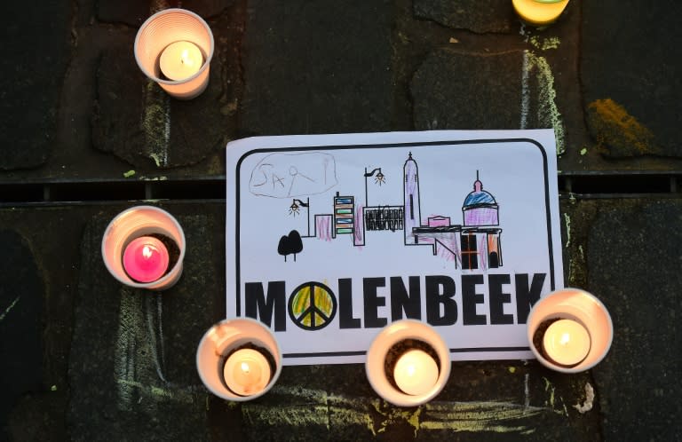 Candles are pictured around a paper reading "Molenbeek" during a candle light vigil to the victims of the Paris attacks in Brussels' Molenbeek district, on November 18, 2015