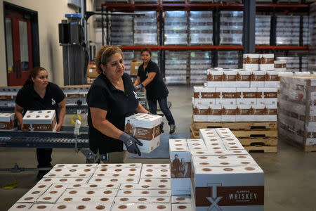 Employees move cases of TX Whiskey at the Firestone & Robertson (F&R) Whiskey Ranch in Forth Worth, Texas, U.S., May 24, 2018. REUTERS/Adrees Latif