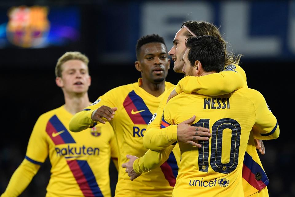 Lionel Messi (10) hugs Antoine Griezmann after scoring Barcelona's goal on Tuesday at Napoli. (Photo by FILIPPO MONTEFORTE/AFP via Getty Images)