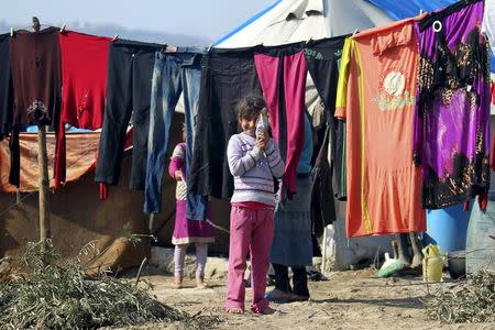 A girl holds up her doll as she stands outside tents housing internally displaced people in Salqin town, in Idlib province, Syria February 9, 2016. REUTERS/Ammar Abdullah