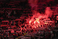 Poland fans light flares during Euro 2024 soccer play-off match between Wales and Poland at Cardiff City Stadium, Wales, Tuesday, March 26, 2024. (AP Photo/Alastair Grant)