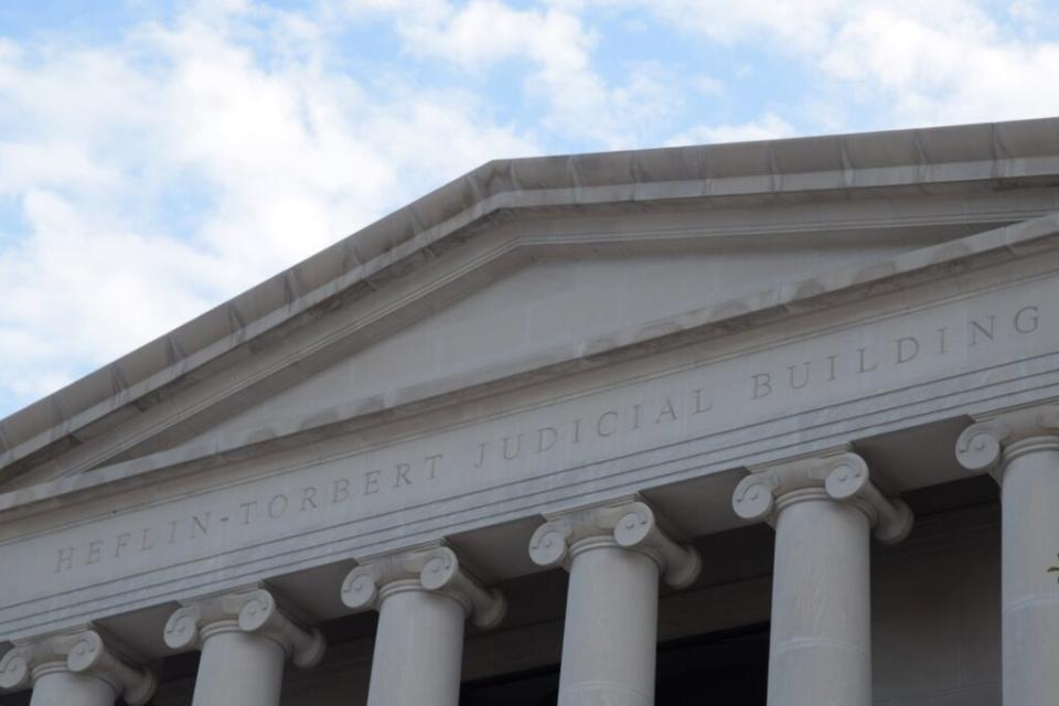 An engraving over six classical-style columns says "Heflin-Torbert Judicial Building."