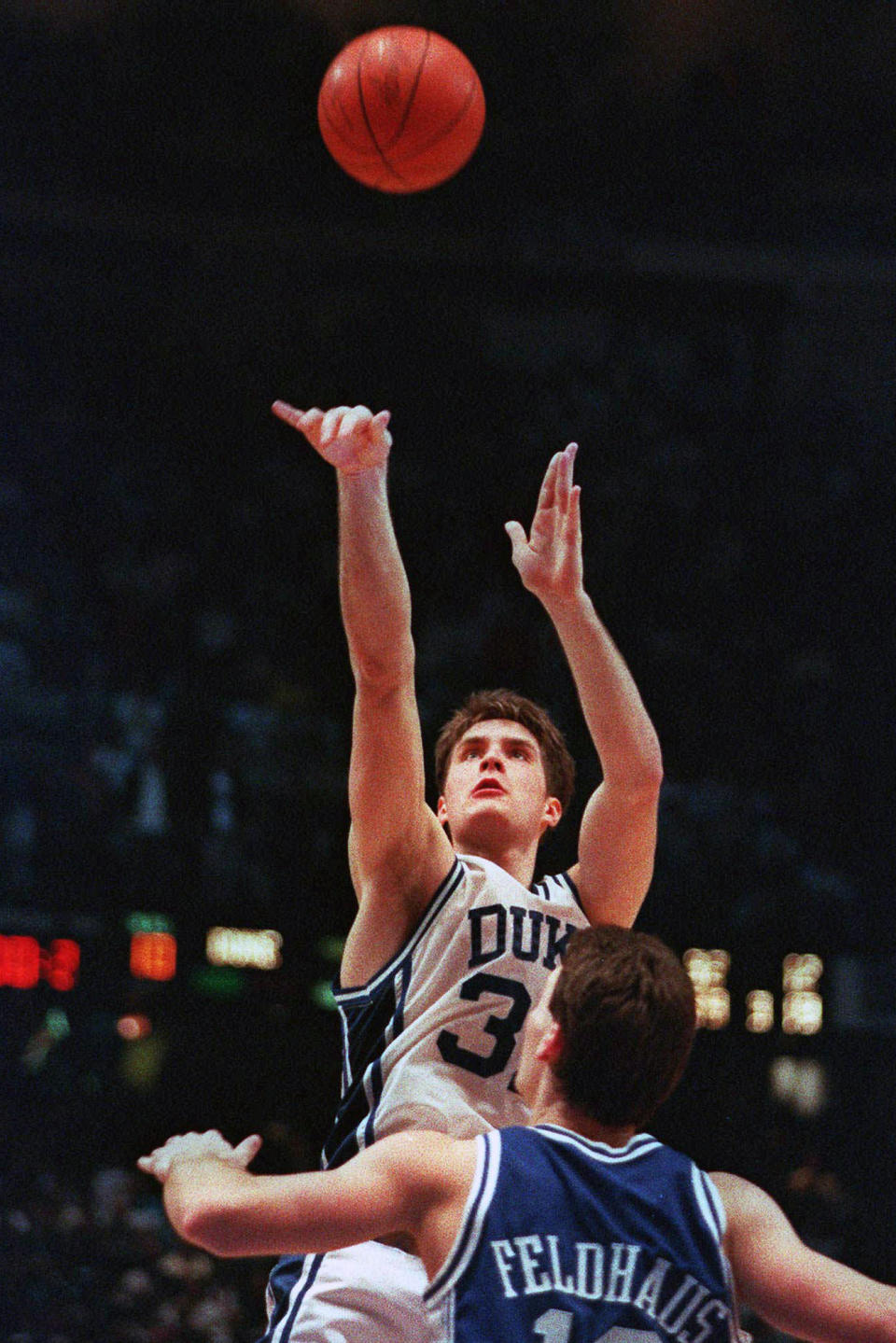 FILE - In this March 28, 1992, file photo, Duke's Christian Laettner takes the winning shot in overtime over Kentucky's Deron Feldhaus for a 104-103 victory in the East Regional final NCAA college basketball game in Philadelphia. A panel of Associated Press sports writers voted in March 2020 on the top 10 men's basketball games in the history of the NCAA Tournament. They are being republished because the sport has been shut down because of the coronavirus pandemic. The Duke vs Kentucky game on March 28, 1992, was voted No. 2. (AP Photo/Charles Arbogast, File)