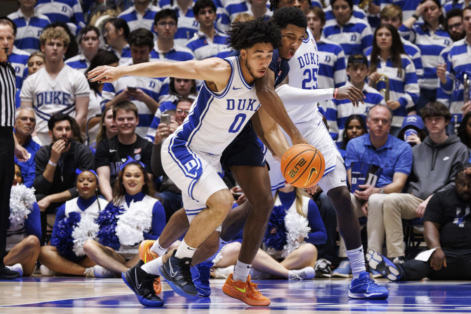 Duke's Jared McCain (0) steals the ball from Virginia's Reece Beekman, right, during the second half of an NCAA college basketball game in Durham, N.C., Saturday, Mar. 2, 2024. (AP Photo/Ben McKeown)