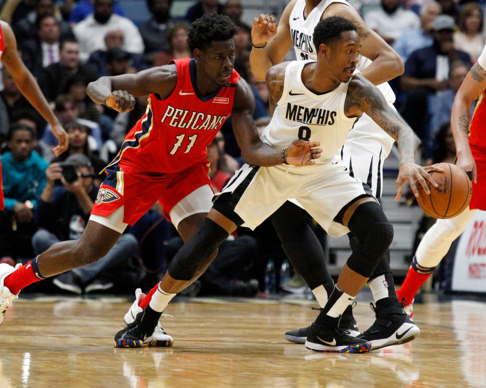 Memphis Grizzlies guard MarShon Brooks (8) keeps the ball from New Orleans Pelicans guard Jrue Holiday (11) during the second half of an NBA basketball game in New Orleans, Wednesday, April 4, 2018. The Pelicans won 123-95. (AP Photo/Scott Threlkeld)