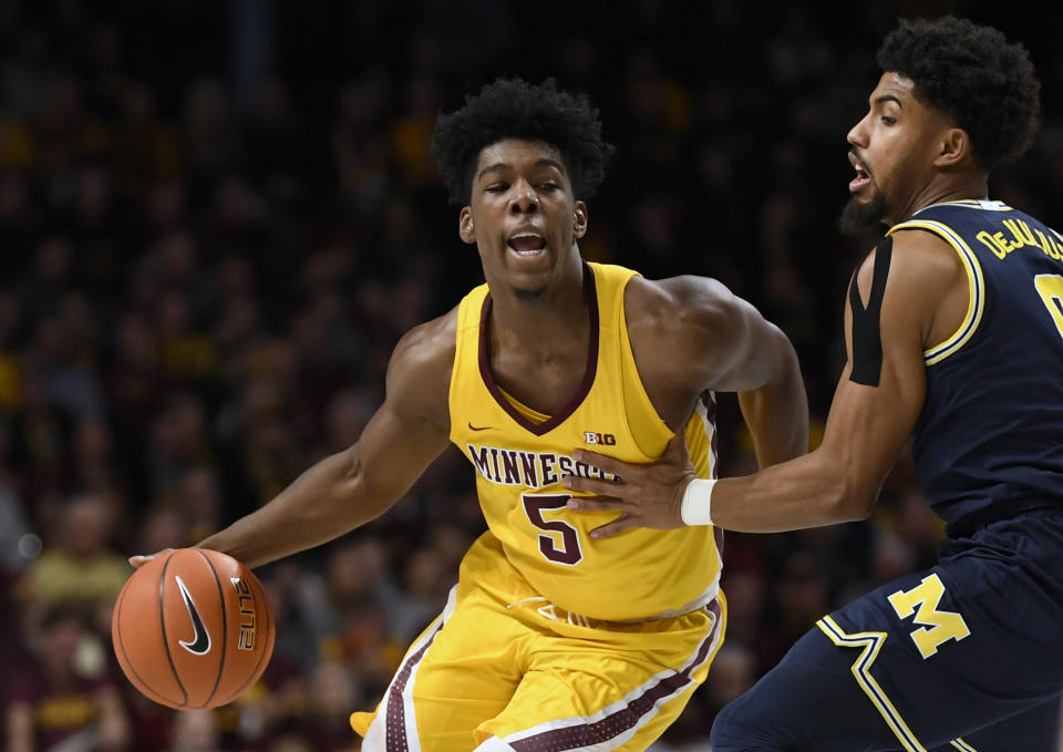 Michigan's David DeJulius, right, guards against Minnesota's Marcus Carr (5) in the first half during an NCAA college basketball game on Sunday, Jan. 12, 2020, in Minneapolis. (AP Photo/Hannah Foslien)