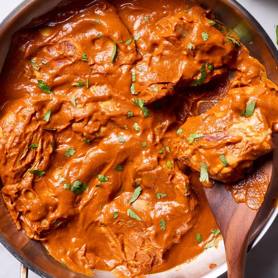 creamy chicken curry in a pan served with rice