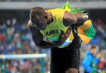 2016 Rio Olympics - Athletics - Final - Men's 200m Final - Olympic Stadium - Rio de Janeiro, Brazil - 18/08/2016. Usain Bolt (JAM) of Jamaica bows after winning the gold medal. REUTERS/Dominic Ebenbichler