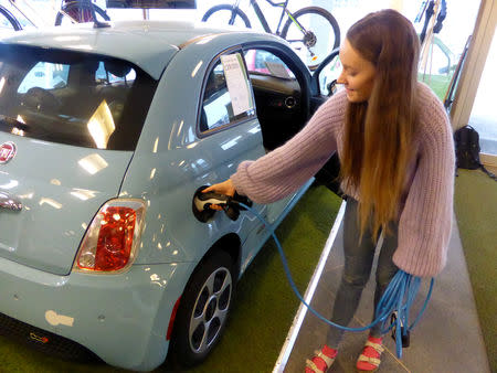 Maiken Skram of Buddy Electric car dealer company shows the charging of a second-hand Fiat 500e, imported from California, U.S., in Oslo, Norway March 15, 2109. Picture taken March 15, 2019. REUTERS/Alister Doyle