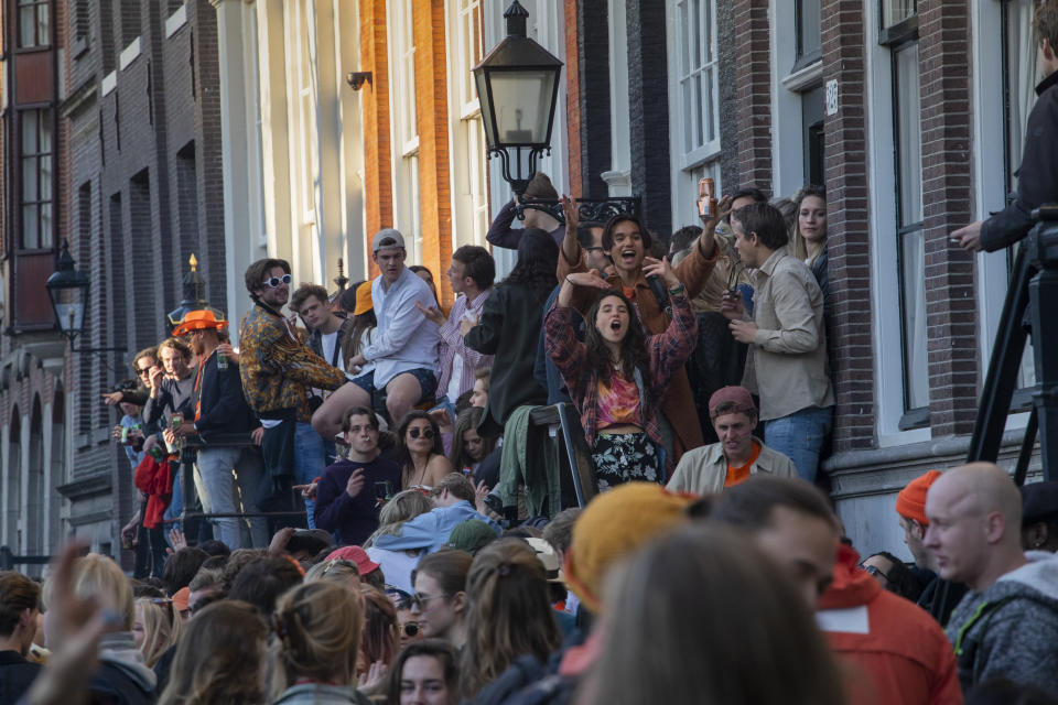 FILE - In this Tuesday, April 27, 2021 file photo, people gather despite authorities urging people to stick to coronavirus social distancing regulations, as they celebrate King's Day in the center of Amsterdam, Netherlands. Dutch zoos and theme parks will be allowed to re-open next week under strict conditions and bars and cafes can extend the opening hours of their outdoor terraces, if coronavirus infections and hospital admissions continue to fall, caretaker Prime Minister Mark Rutte announced Tuesday, May 11, 2021. (AP Photo/Peter Dejong, file)