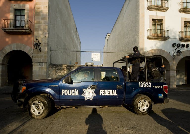 Federal police patrol the streets in Morelia, Michoacan, Mexico, on November 13, 2011. A Mexican mayor was having breakfast with his wife in a restaurant when he was gunned down this week. To avoid a similar fate, mayors in the western state of Michoacan admit they must pay off drug cartels