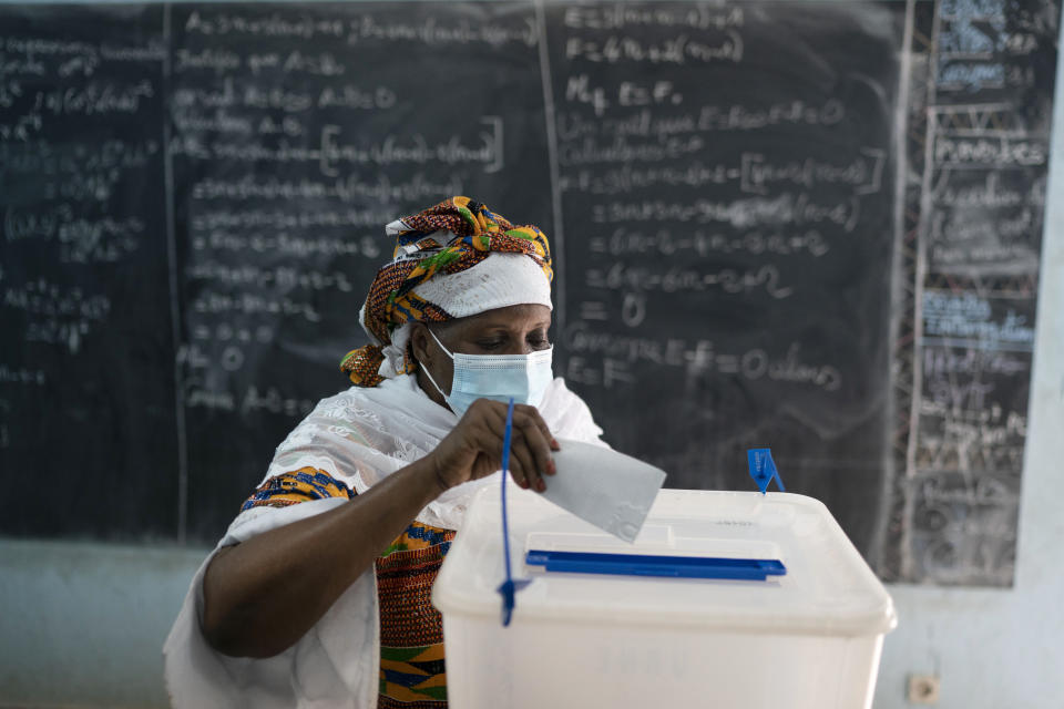 A woman casts her vote during presidential election in Abidjan, Ivory Coast, Saturday, Oct. 31, 2020. Tens of thousands of security forces deployed across Ivory Coast on Saturday as the leading opposition parties boycotted the election, calling President Alassane Ouattara's bid for a third term illegal. (AP Photo/Leo Correa)