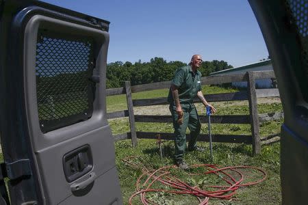 Scott Coyle, an inmate at the State of New York Wallkill Correctional Facility, gets a drink of water from a hose on a prison farm in Wallkill, New York June 16, 2014. REUTERS/Shannon Stapleton