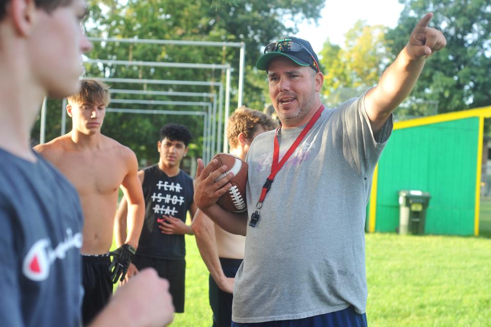 Jeff Paiva, right, was a first-year head coach for the North Smithfield/Mount St. Charles football team last fall. His program is on hold after hazing allegations.