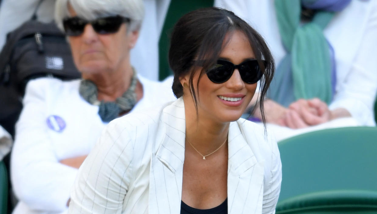 Meghan wore a new necklace with an 'A' for Archie at Wimbledon. [Photo: Getty]