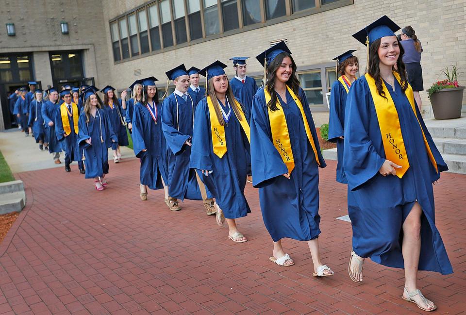 Graduates walk to the school auditorium for the Archbishop Williams High School graduation Thursday, May 25, 2023.