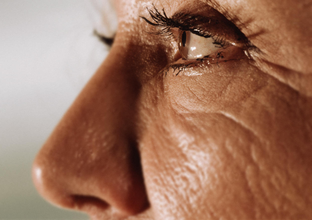 A profile of an older woman as she looks straight ahead.