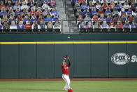 Texas Rangers right fielder Shin-Soo Choo fields a fly out by Los Angeles Angels' Albert Pujols in the second inning of a baseball game in Arlington, Texas, Friday, Aug. 7, 2020. Card board cutouts depicting fans are shown in the seats behind Choo. (AP Photo/Tony Gutierrez)