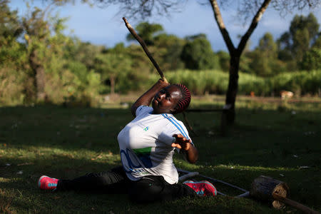 Disabled javelin thrower Nelly Jeptoo Sile, 42, demonstrates how she practices with a home made wooden javelin, in her home in Turbo, western Kenya, April 11, 2016. REUTERS/Siegfried Modola