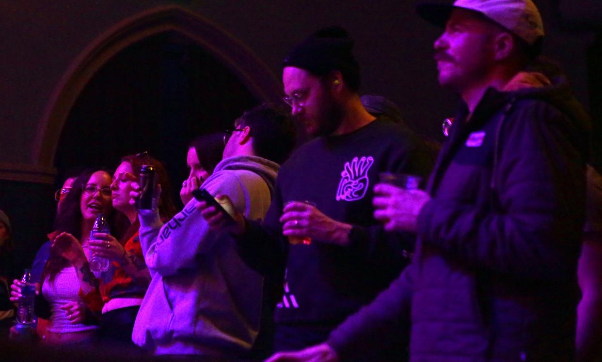 Fans stand to watch Halfloves perform during the Englert Theatre's second local showcase Saturday, Feb. 10, 2024 in Downtown Iowa City.