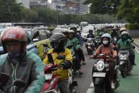 Motorist make their way through morning traffic in Jakarta, Indonesia, Wednesday, Feb. 7, 2024. A presidential election in Indonesia, the world's third-largest democracy, is highlighting the choices to be made as the country seeks to exploit its rich reserves of nickel and other resources that are vital to the global transition away from fossil fuels. (AP Photo/Dita Alangkara)