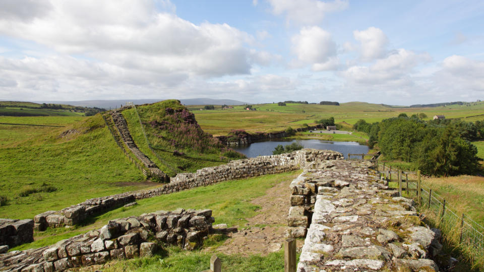 Hadrian's Wall Path National Trail with a section of the Roman-built wall and rolling hills