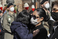 Zakia Seddiki, wife of the Italian ambassador to the Democratic Republic of Congo Luca Attanasio, holds one of her children at the end of the state funeral for Attanasio and Italian Carabinieri police officer Vittorio Iacovacci, in Rome, Thursday, Feb. 25, 2021. Italy paid tribute Thursday to its ambassador to Congo and his bodyguard who were killed in an attack on a U.N. convoy, honoring them with a state funeral and prayers for peace in Congo and all nations "torn by war and violence." (AP Photo/Andrew Medichini)
