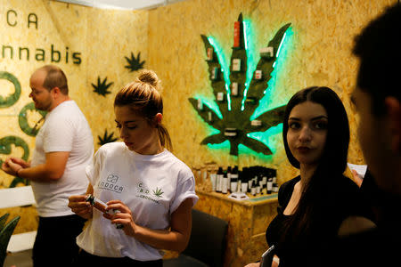 FILE PHOTO: Customers and staff are seen inside a store during the Balkannabis Expo 2018, in Athens, Greece, June 2, 2018.REUTERS/Costas Baltas