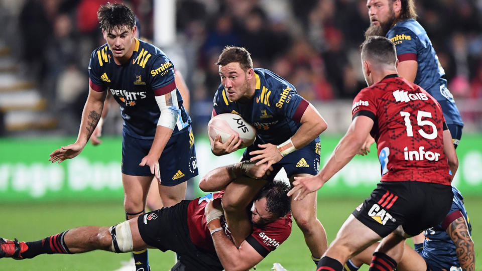 Mitchell Hunt of the Highlanders is tackled by the Crusaders' Samuel Whitelock during their Super Rugby Aotearoa clash on Friday night. (Photo by Kai Schwoerer/Getty Images)