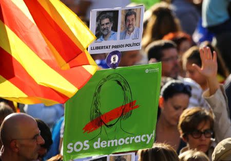 A banner reading "Freedom Political Prisoners" is held up during a demonstration organised by Catalan pro-independence movements ANC (Catalan National Assembly) and Omnium Cutural, following the imprisonment of their two leaders Jordi Sanchez and Jordi Cuixart, in Barcelona, Spain, October 21, 2017. REUTERS/Ivan Alvarado