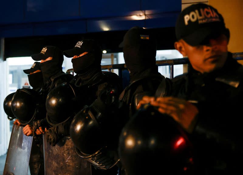 Police and military officials stand outside the Flagrancy Unit, where former Ecuador Vice President Jorge Glas is believed to be detained, in Quito