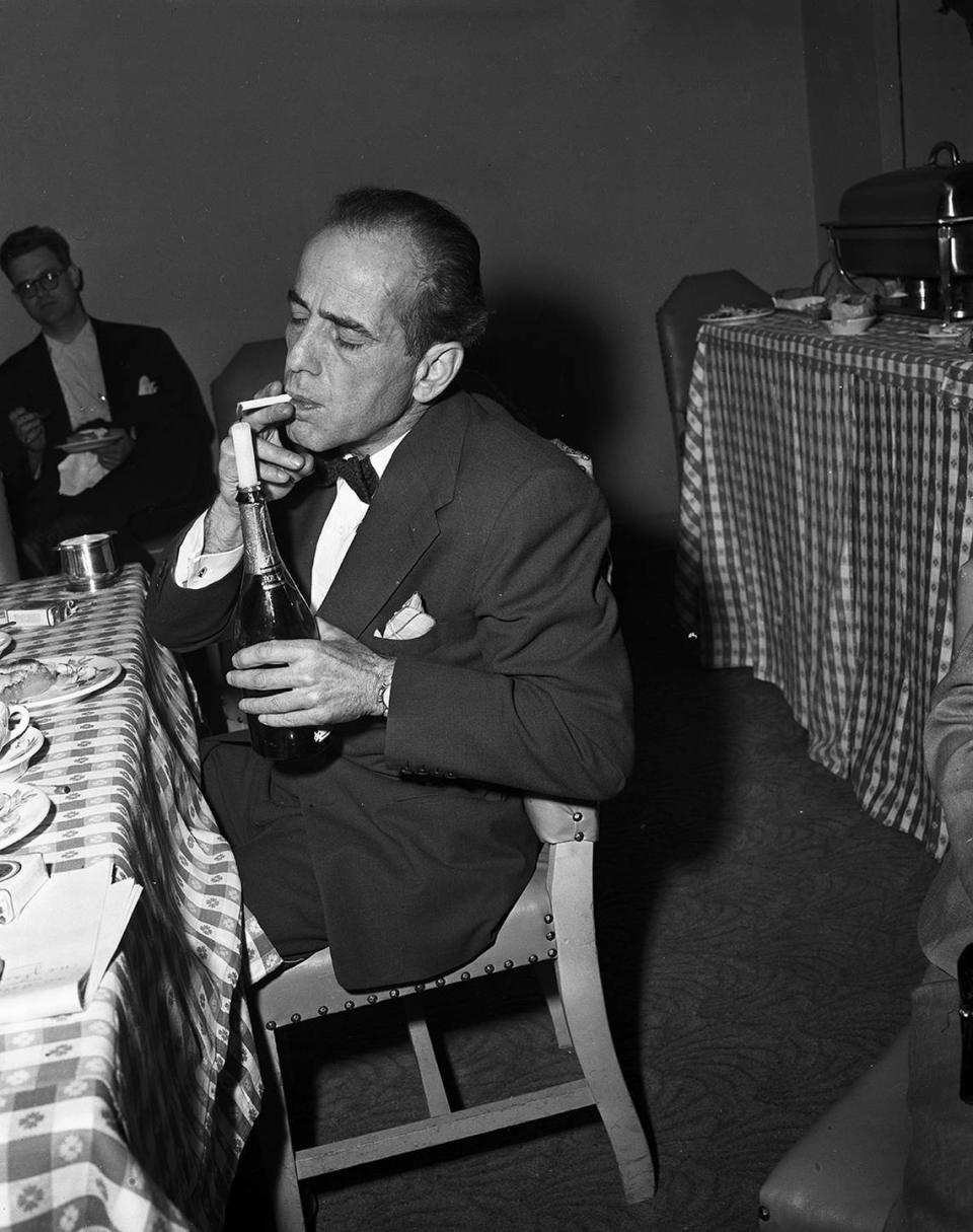 April 14, 1952: Humphrey Bogart, Academy Award winning actor, lighting a cigarette in Fort Worth. Fort Worth Star-Telegram archives/UT Arlington Special Collections