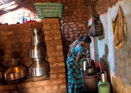 Shivarti, second wife of Namdeo, empties a water pitcher as she gets ready to fill water from a well outside Denganmal village, Maharashtra, April 21, 2015.REUTERS/Danish Siddiqui