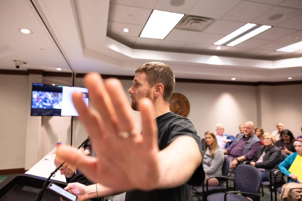 A public commenter attempts to shield a Sentinel freelance photographer from taking a photo. Immediately prior, he thanked the board “for upholding our constitutional freedoms under all circumstances, even though as evidenced tonight, the free exercise thereof makes us uncomfortable.”