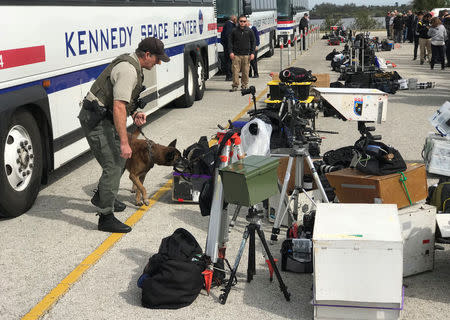 A security officer checks remote equipment to be used by journalists to cover launch of a SpaceX Falcon Heavy rocket on its first demonstration flight at the Kennedy Space Center in Cape Canaveral, Florida, U.S., February 5, 2018. The launch is scheduled for February 6. REUTERS/Joe Skipper